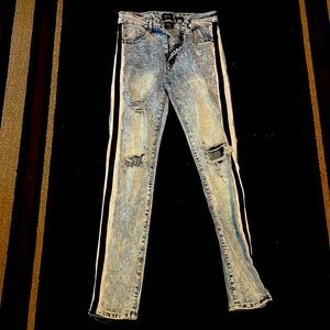 Blue jeans with a black/white side stripe with holes. Skinny fit size medium